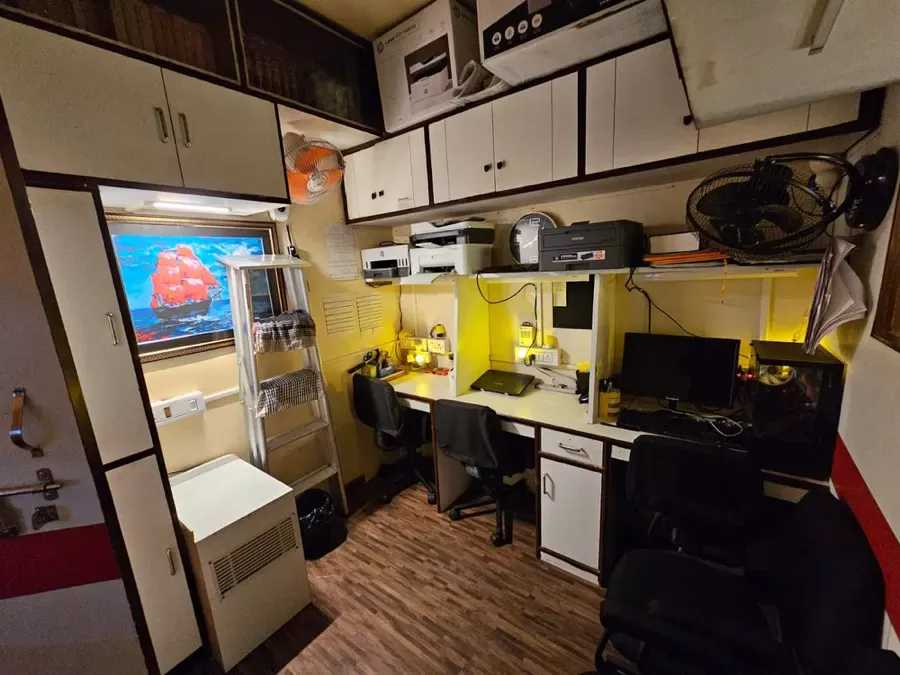 Associates' workstation bay with computers and printers at the Kolkata chambers