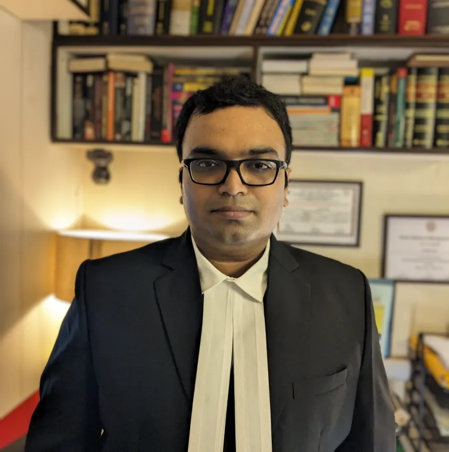 Advocate Sudip Patra in the law chambers with law books behind him