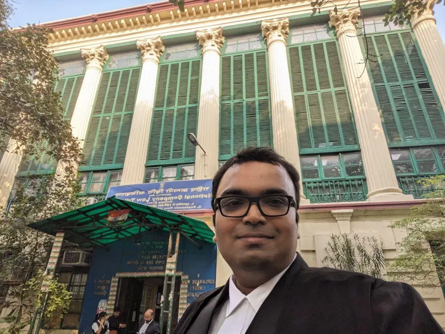Advocate Sudip Patra in front of the Calcutta High Court's green-shuttered annexe building