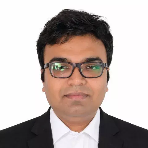 Portrait of Advocate Sudip Patra, founder of Patra's Law Chambers, in a dark suit and glasses